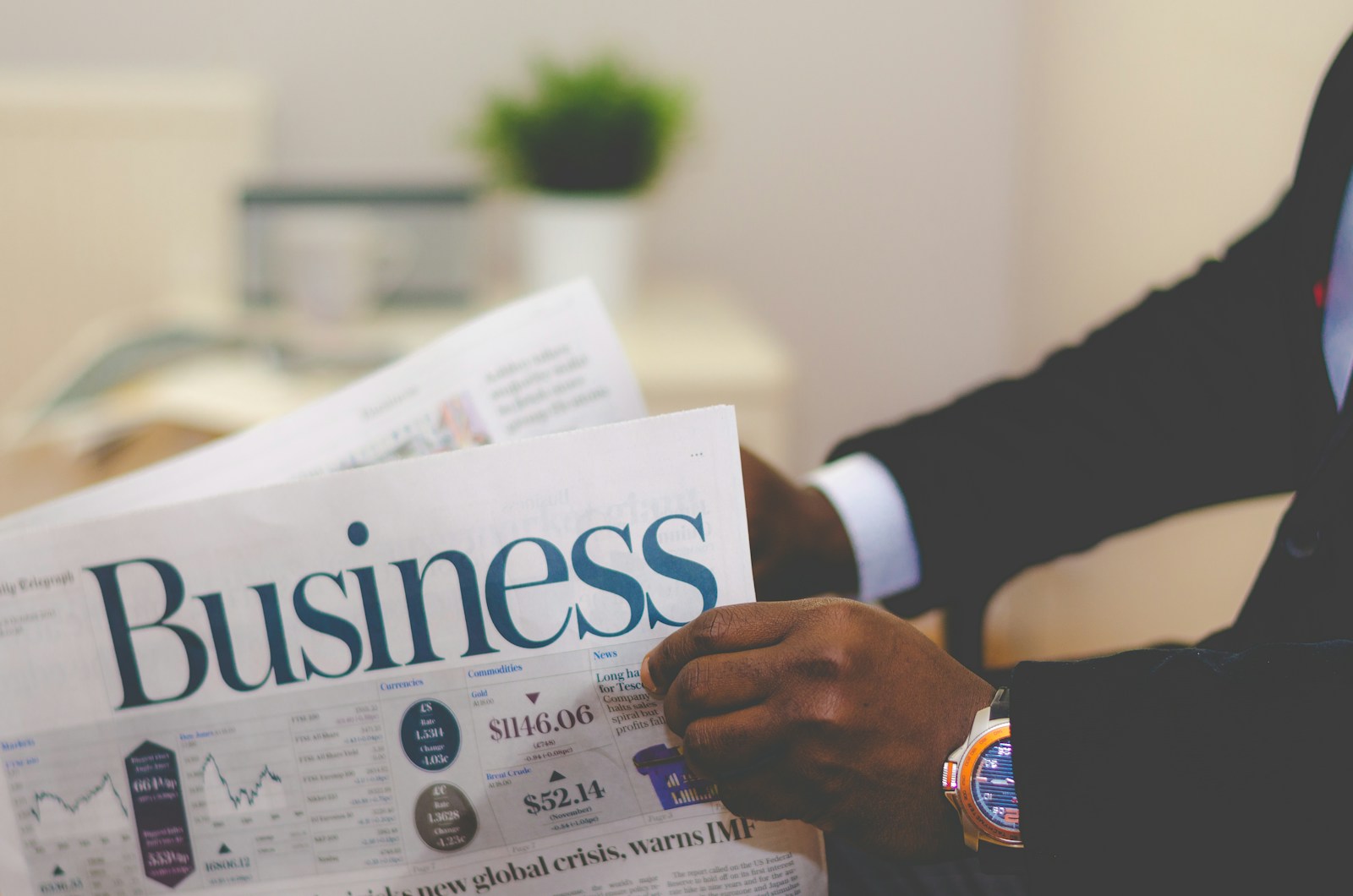 person wearing suit reading business, General Liability, newspaper